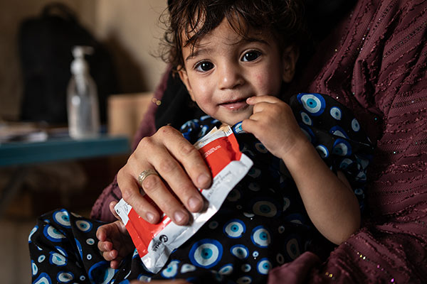 CH1113Roya (18 mths) is malnourished and eats therapeutic food at a clinic in Afghanistan